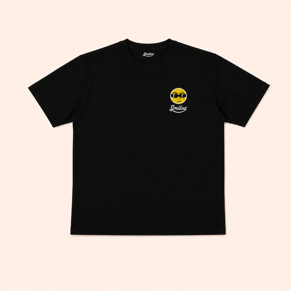 Black Smiloz Cooleo T-shirt on a warm blush studio background