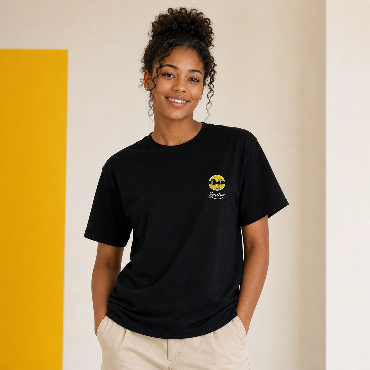 Black young adult model wearing the black Cooleo character T-shirt