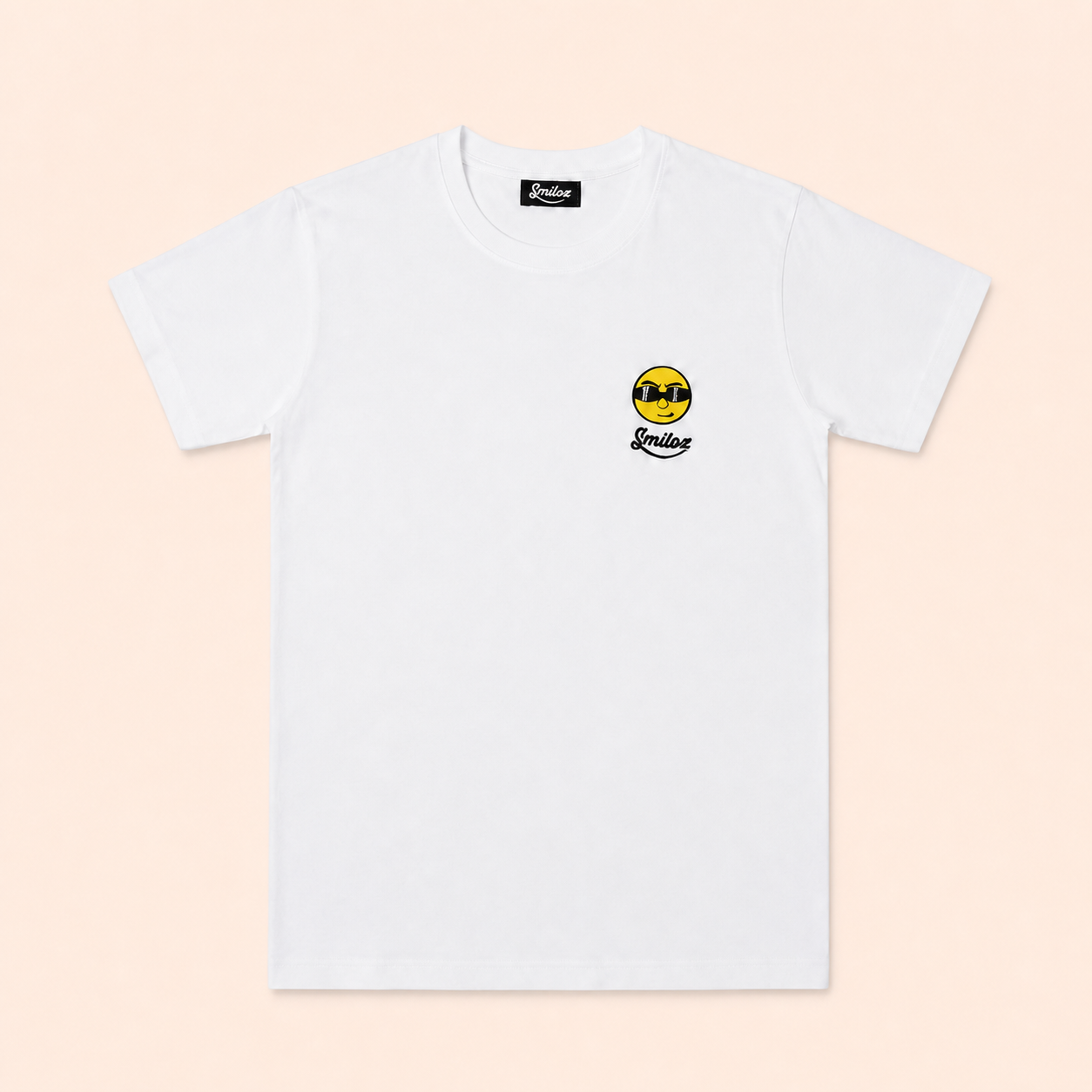 White Smiloz Cooleo T-shirt on a warm blush studio background