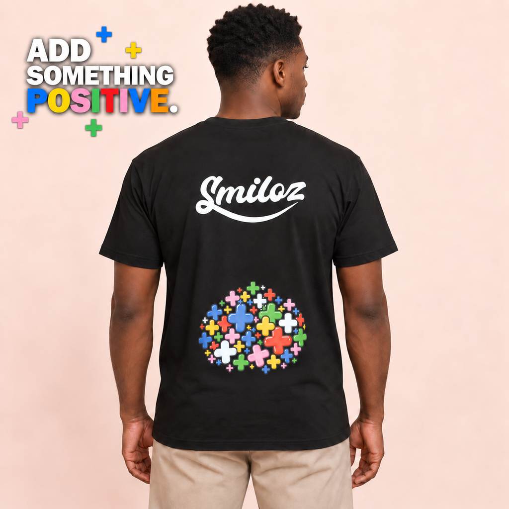 Back view of model wearing the black Smiloz Multicolour Plus signs T-shirt with Add Something Positive campaign slogan